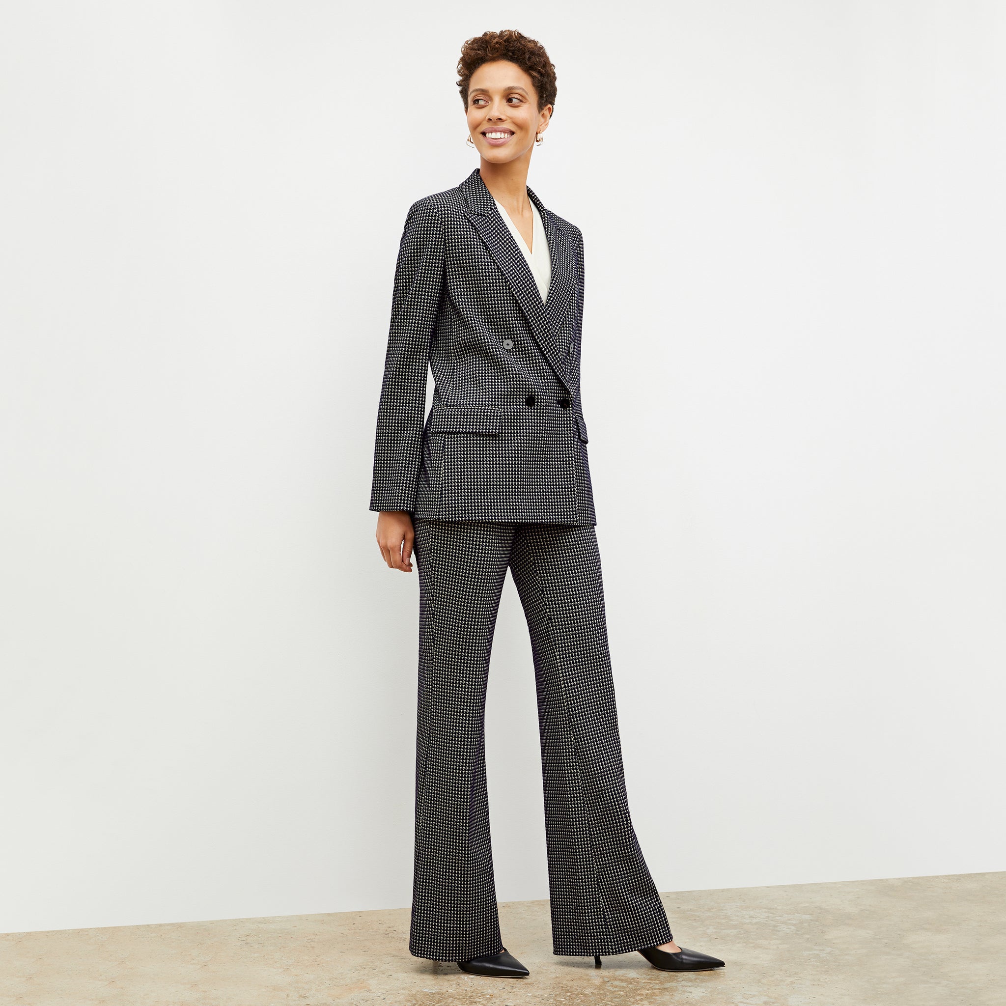 Front image of a woman wearing the ohara blazer in black and white