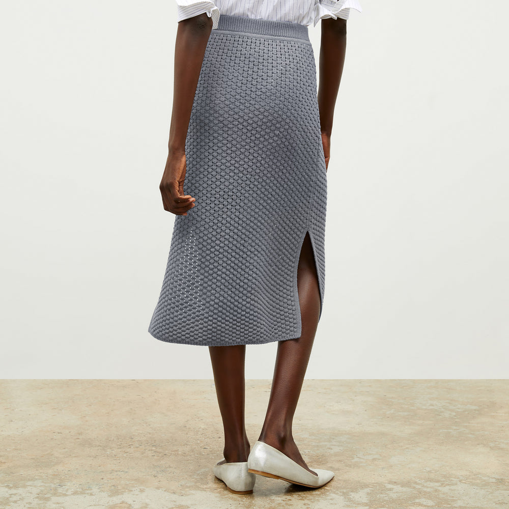 front image of a woman wearing the senga skirt in flint gray