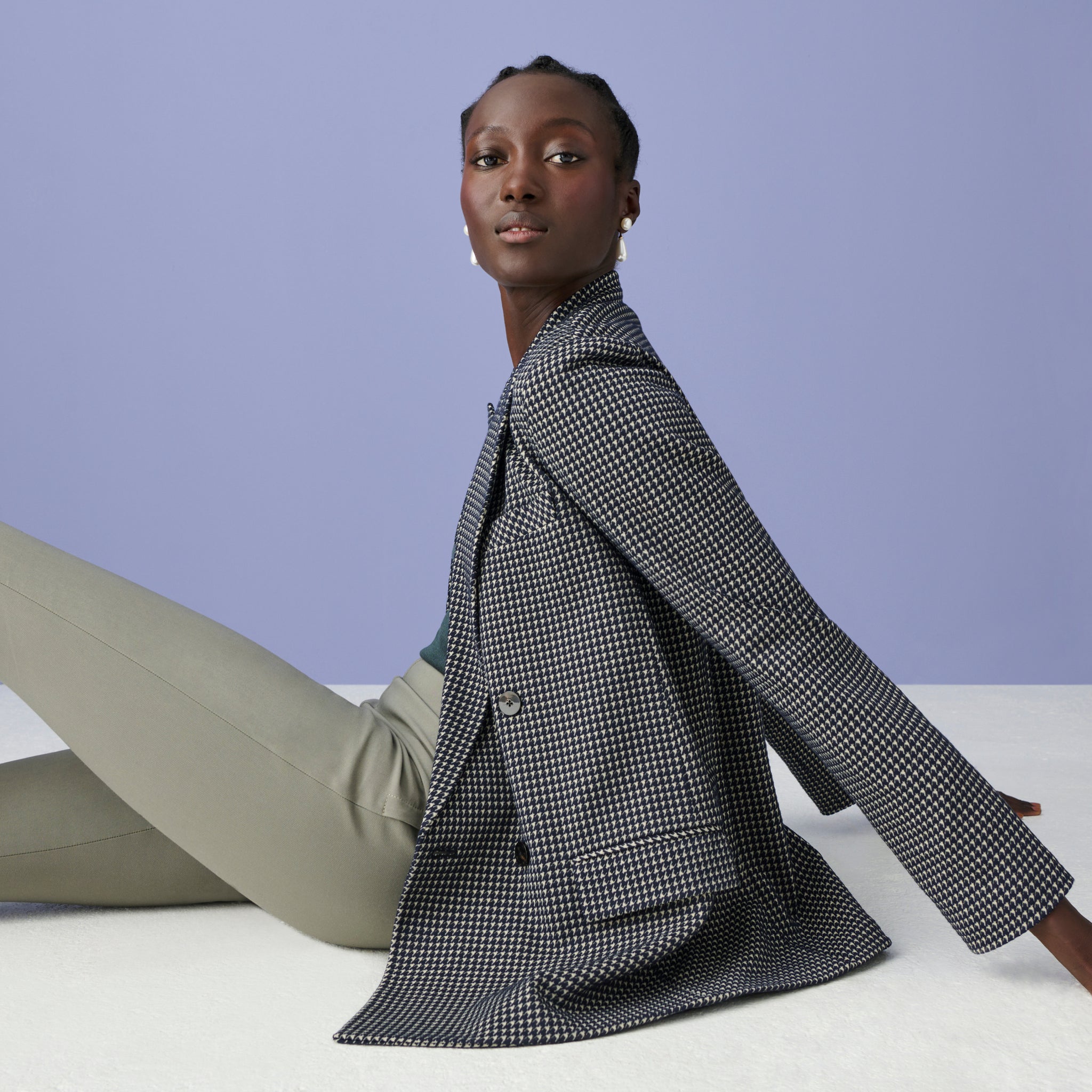 Image of a woman sitting on the ground in the O'Hara Blazer in Indigo and White