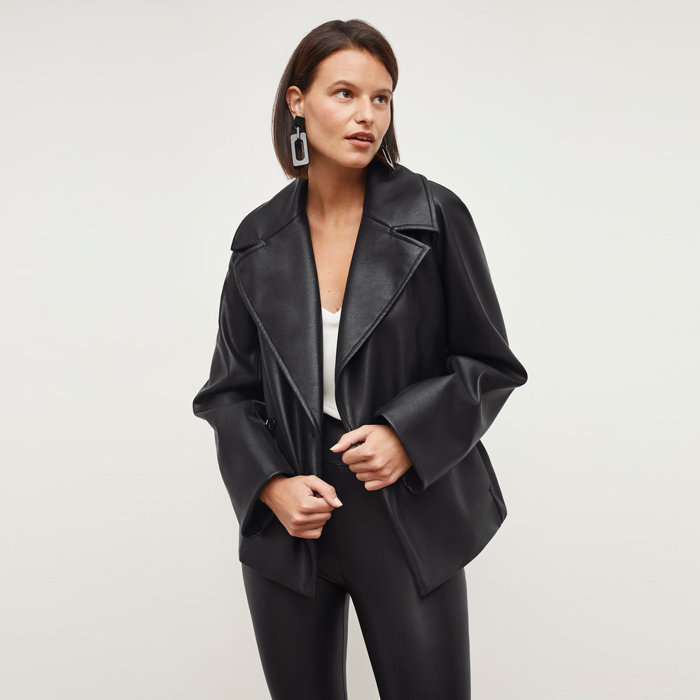 Front image of a woman standing wearing the Alphonso Jacket—Vegan Leather in Black