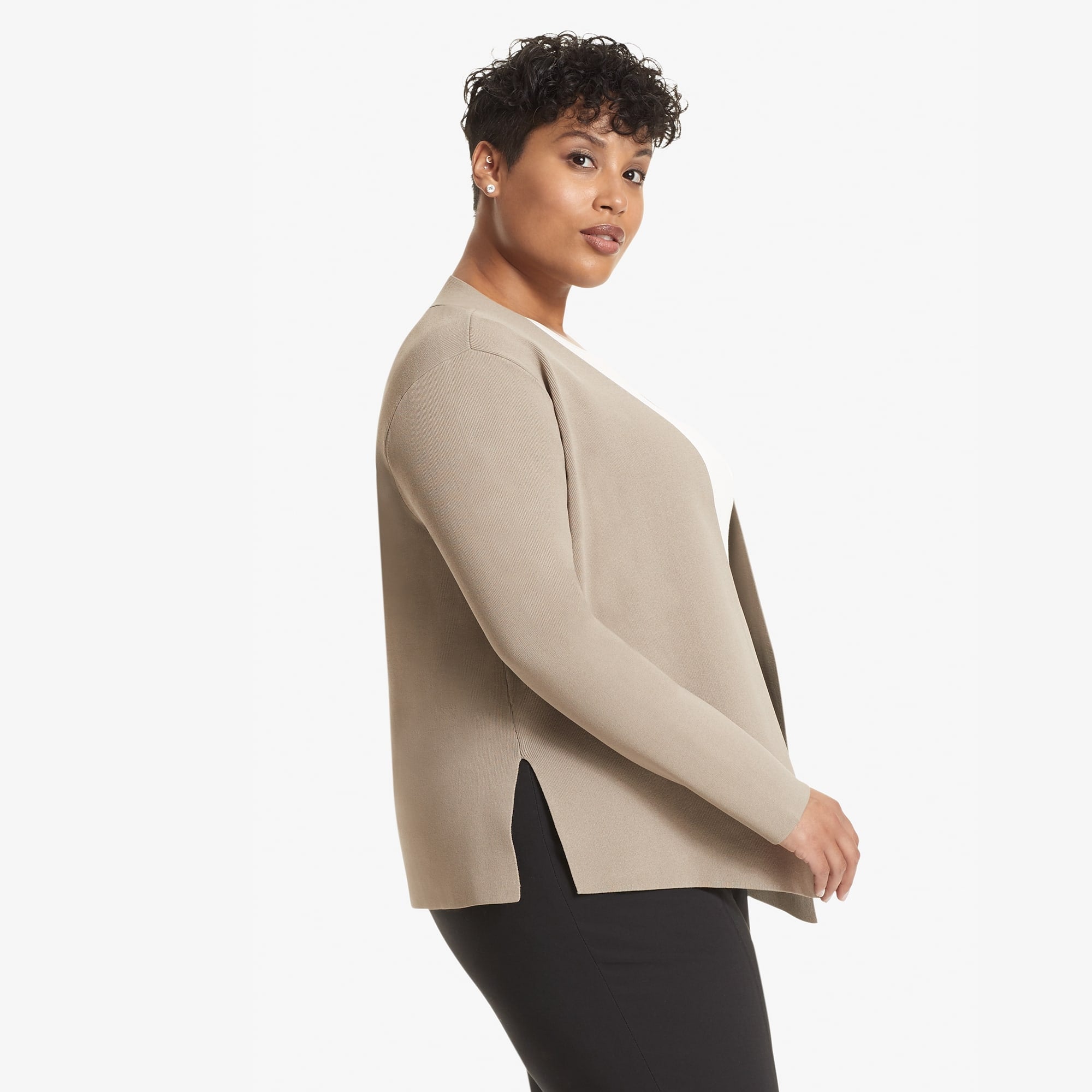 Side image of a woman standing wearing the Woolf jardigan in Taupe