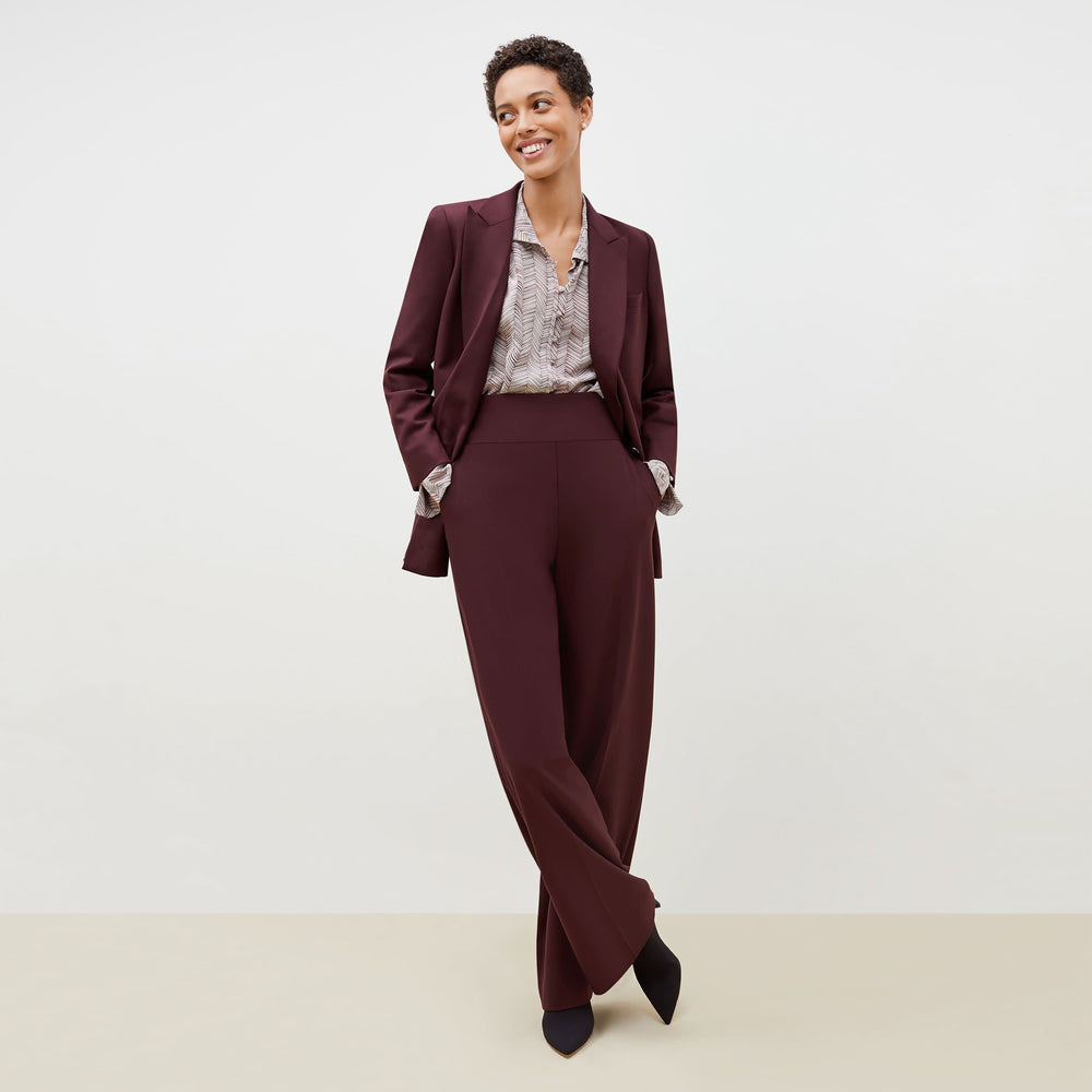 Front image of a woman standing wearing the Hadley Pant-Sharkskin in garnet