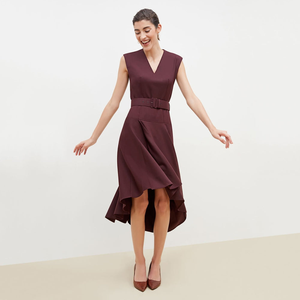 Front image of a woman standing wearing the Kelsey Dress-Sharkskin in garnet