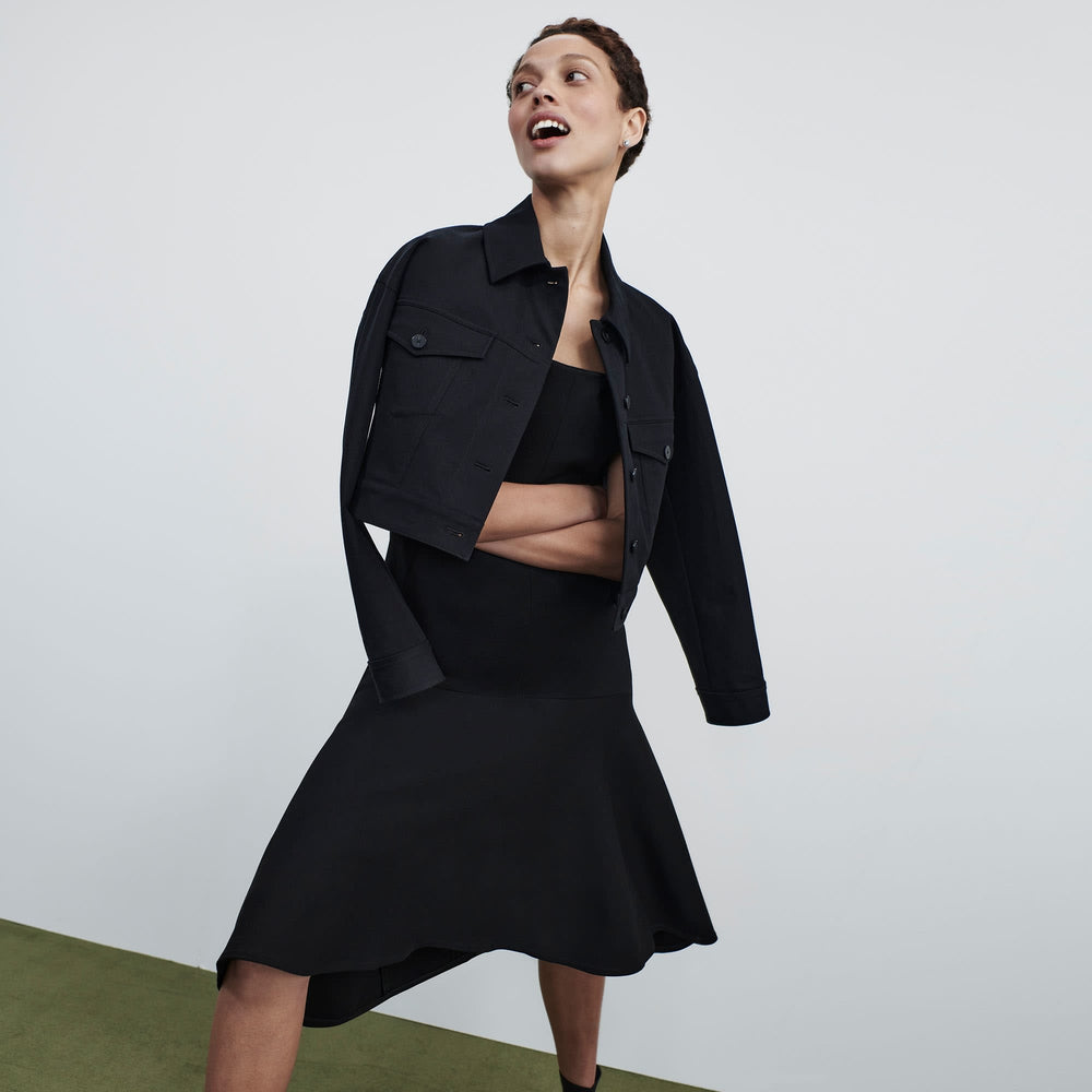 Front image of a woman standing wearing the james dress in black