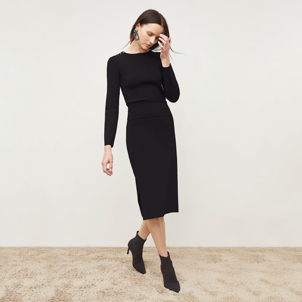 Front image of a woman standing wearing the Malin Top—Jardigan Knit in Black